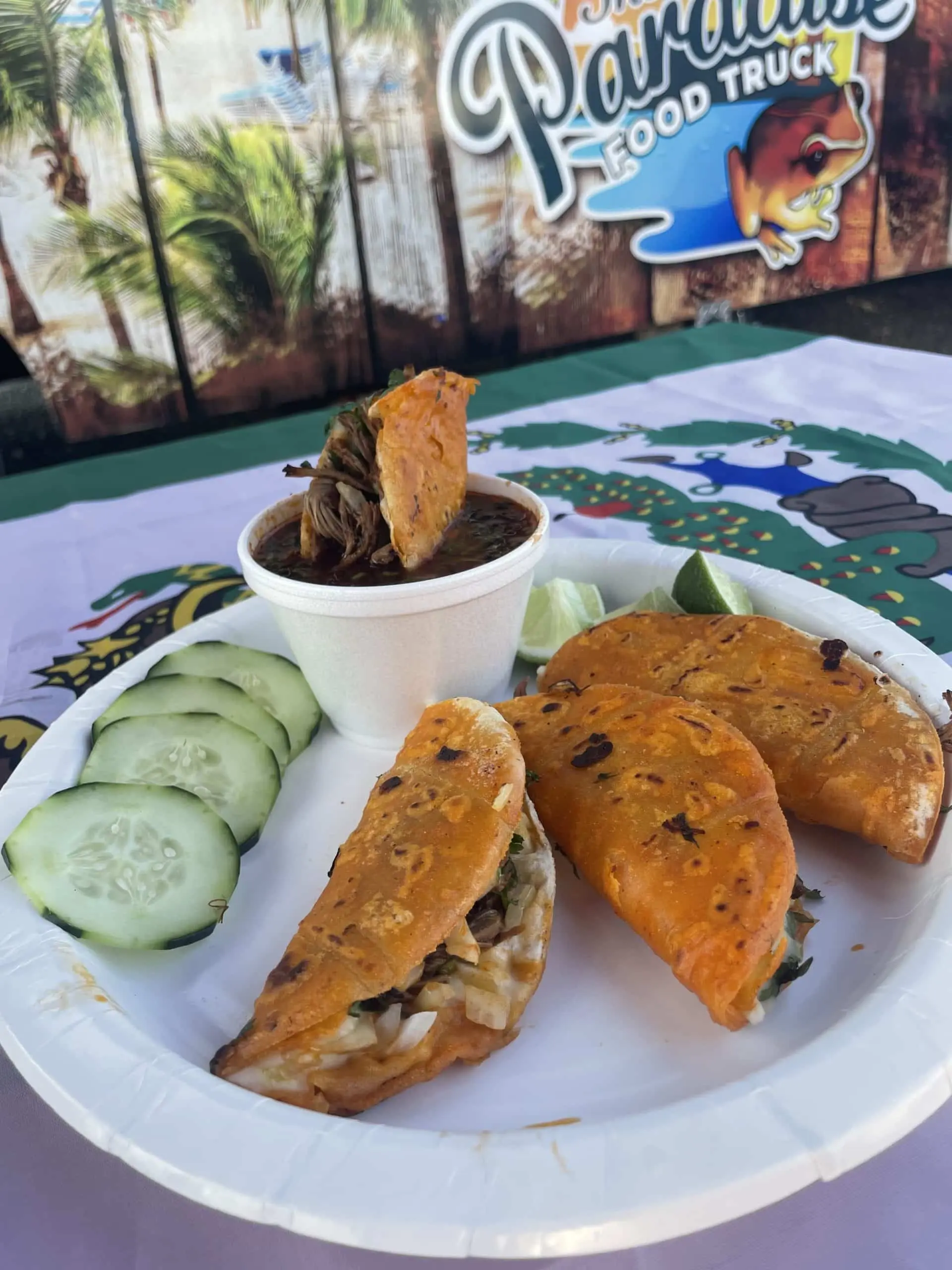 a plate of birria tacos with dipping broth